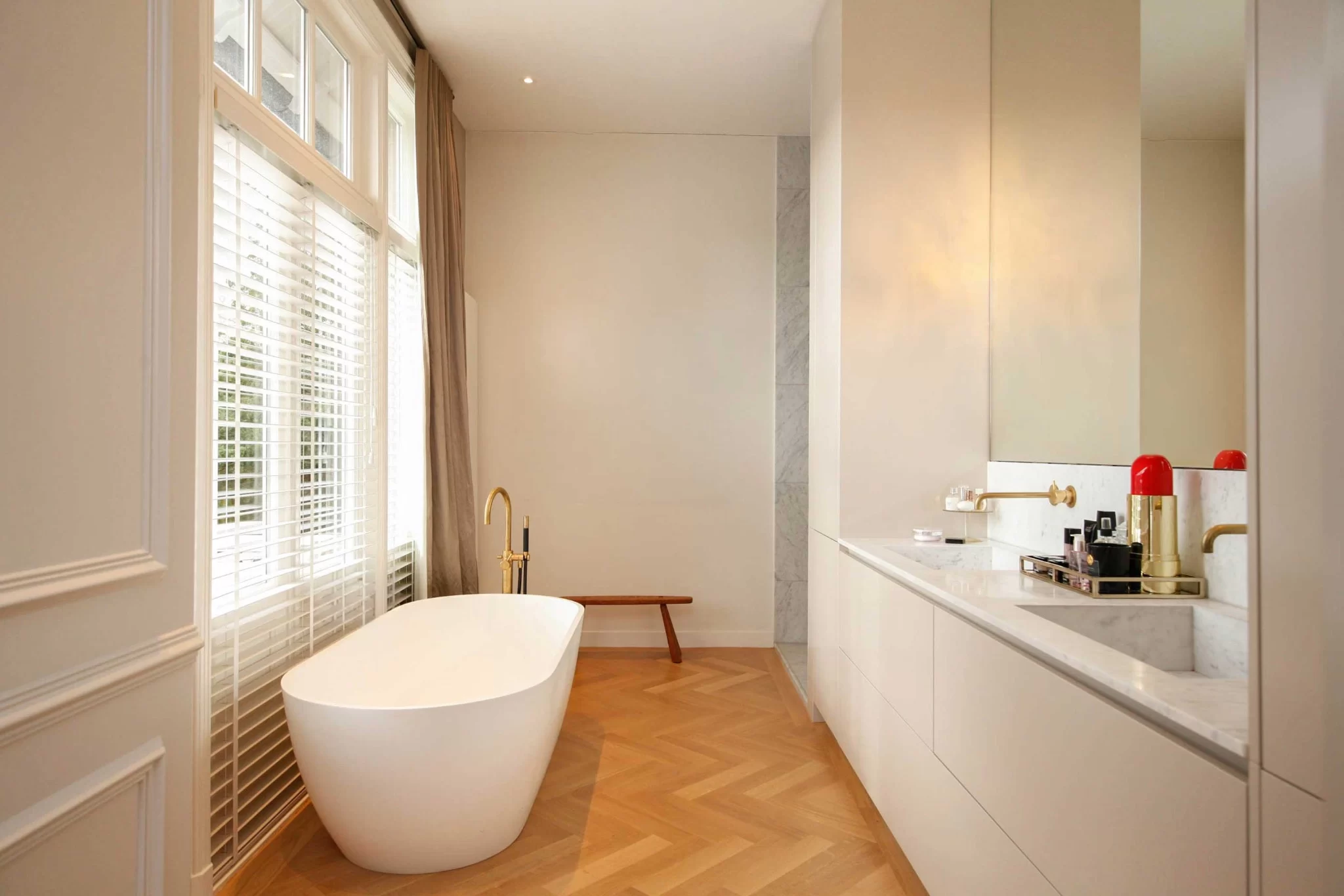 Badkamer met vrijstaand bad en dubbele wastafel